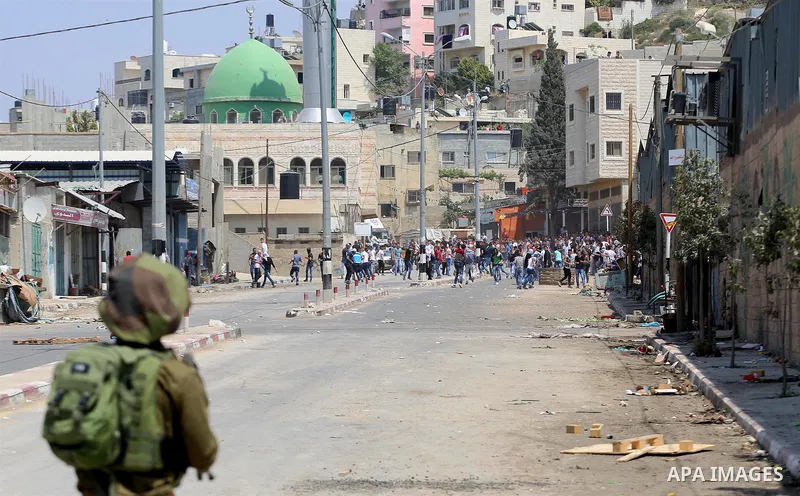 Palestinian protesters hurl stones towards Israeli security forces during clashes at a protest in support of Palestinian prisoners on hunger strike in Israeli jails, in the West Bank village of Beita, near Nablus May 5,...
