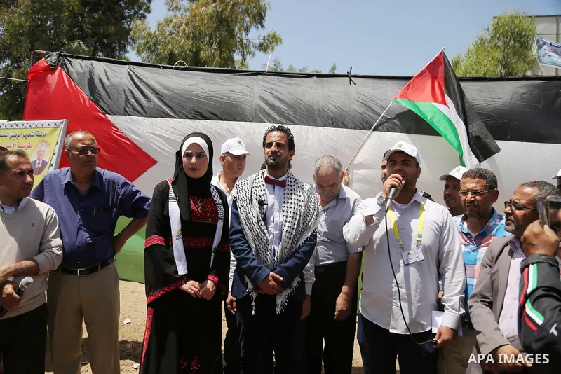 A Palestinian groom and his bride take part in their marriage ceremony at a sit-in in support of Palestinian hunger-striking prisoners held in Israeli jails, on May 8, 2017, in Gaza City. Photo by Ashraf Amra