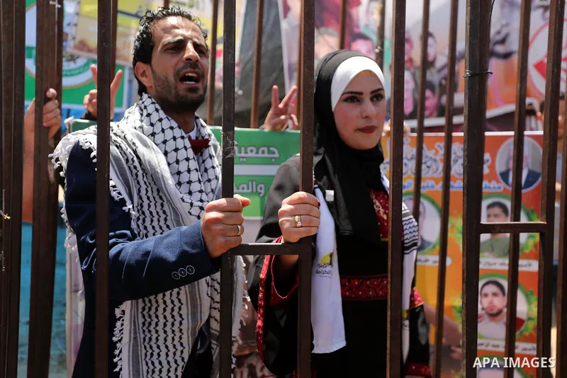 A Palestinian groom and his bride take part in their marriage ceremony at a sit-in in support of Palestinian hunger-striking prisoners held in Israeli jails, on May 8, 2017, in Gaza City. Photo by Ashraf Amra