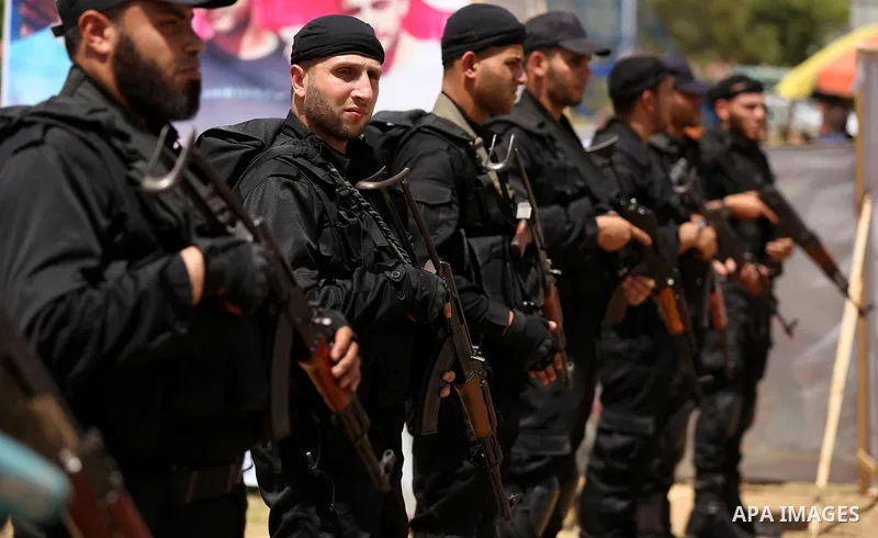 Palestinian ecurity forces stand guard during a visit of newly elected Hamas chief, Ismail Haniya, to protesters taking part in a sit-in in support of Palestinian hunger-striking prisoners held in Israeli jails, on May 8...