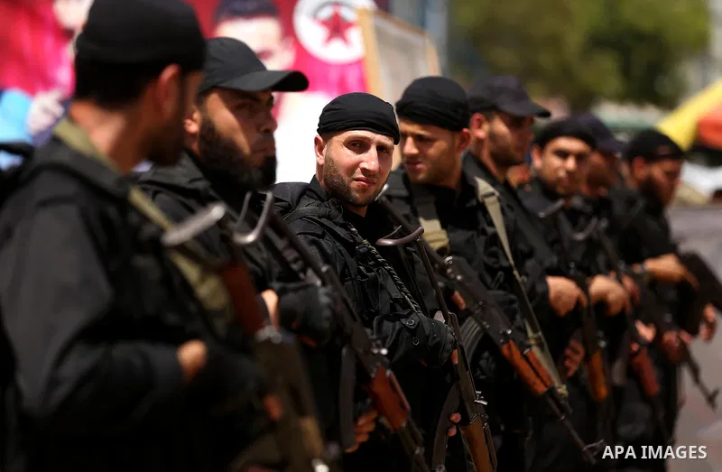 Palestinian ecurity forces stand guard during a visit of newly elected Hamas chief, Ismail Haniya, to protesters taking part in a sit-in in support of Palestinian hunger-striking prisoners held in Israeli jails, on May 8...
