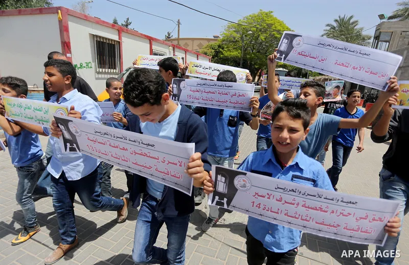 Palestinian children hold banners during a sit-in in support of Palestinian hunger-striking prisoners held in Israeli jails in front of the headquarter United Nation "UNSCO", on May 9, 2017, in Gaza City. Photo by Mohamm...
