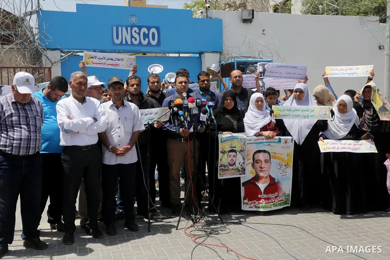 Palestinians hold banners during a sit-in in support of Palestinian hunger-striking prisoners held in Israeli jails in front of the headquarter United Nation "UNSCO", on May 9, 2017, in Gaza City. Photo by Mohammed Asad