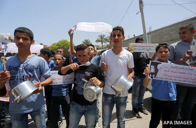 Palestinian children hold banners during a sit-in in support of Palestinian hunger-striking prisoners held in Israeli jails in front of the headquarter United Nation "UNSCO", on May 9, 2017, in Gaza City. Photo by Mohamm...