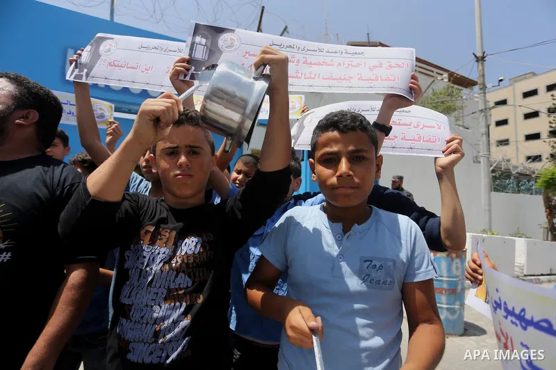 Palestinian children hold banners during a sit-in in support of Palestinian hunger-striking prisoners held in Israeli jails in front of the headquarter United Nation "UNSCO", on May 9, 2017, in Gaza City. Photo by Mohamm...