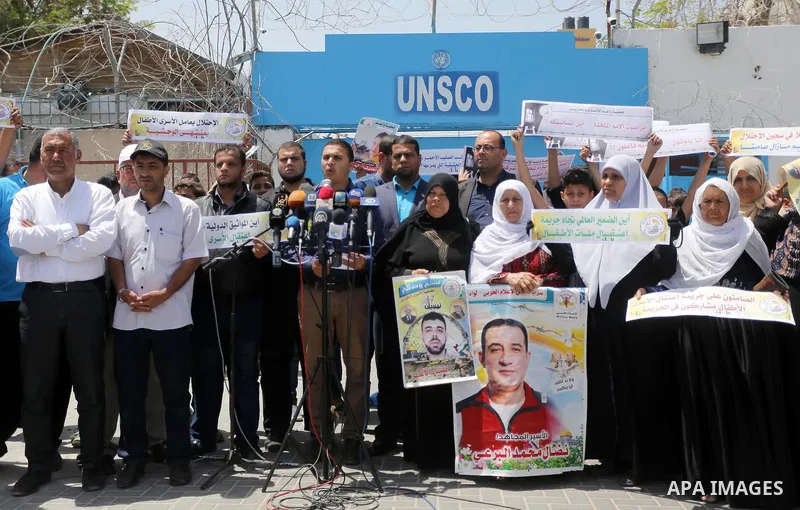 Palestinians hold banners during a sit-in in support of Palestinian hunger-striking prisoners held in Israeli jails in front of the headquarter United Nation "UNSCO", on May 9, 2017, in Gaza City. Photo by Mohammed Asad