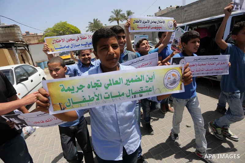 Palestinian children hold banners during a sit-in in support of Palestinian hunger-striking prisoners held in Israeli jails in front of the headquarter United Nation "UNSCO", on May 9, 2017, in Gaza City. Photo by Mohamm...