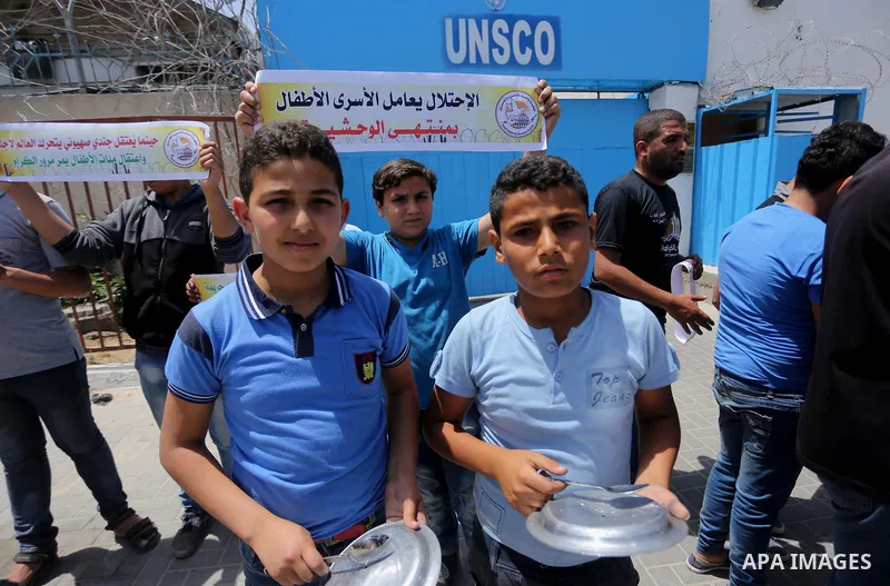 Palestinian children hold banners during a sit-in in support of Palestinian hunger-striking prisoners held in Israeli jails in front of the headquarter United Nation "UNSCO", on May 9, 2017, in Gaza City. Photo by Mohamm...