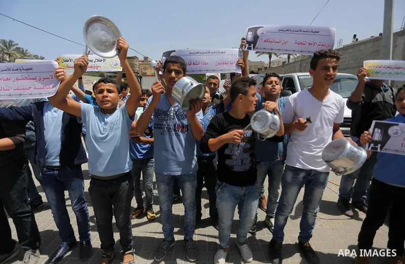 Palestinian children hold banners during a sit-in in support of Palestinian hunger-striking prisoners held in Israeli jails in front of the headquarter United Nation "UNSCO", on May 9, 2017, in Gaza City. Photo by Mohamm...