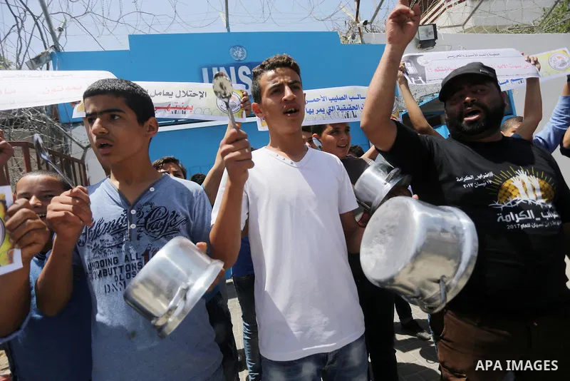 Palestinian children hold banners during a sit-in in support of Palestinian hunger-striking prisoners held in Israeli jails in front of the headquarter United Nation "UNSCO", on May 9, 2017, in Gaza City. Photo by Mohamm...