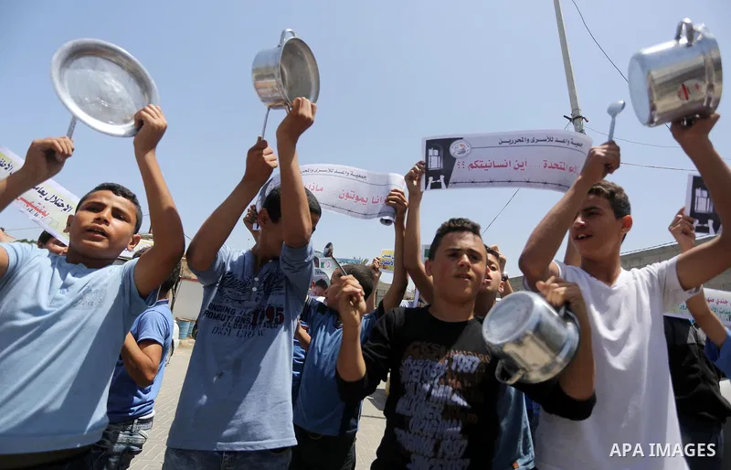 Palestinian children hold banners during a sit-in in support of Palestinian hunger-striking prisoners held in Israeli jails in front of the headquarter United Nation "UNSCO", on May 9, 2017, in Gaza City. Photo by Mohamm...