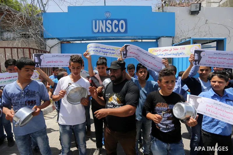 Palestinian children hold banners during a sit-in in support of Palestinian hunger-striking prisoners held in Israeli jails in front of the headquarter United Nation "UNSCO", on May 9, 2017, in Gaza City. Photo by Mohamm...