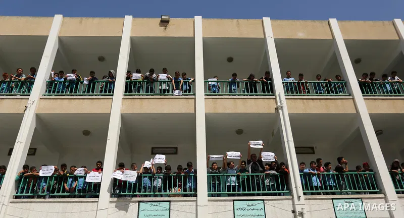 Palestinian students hold banners during a protest against Israeli blockade of the Gaza Strip, in Gaza city, on May 10, 2017. Photo by Ashraf Amra