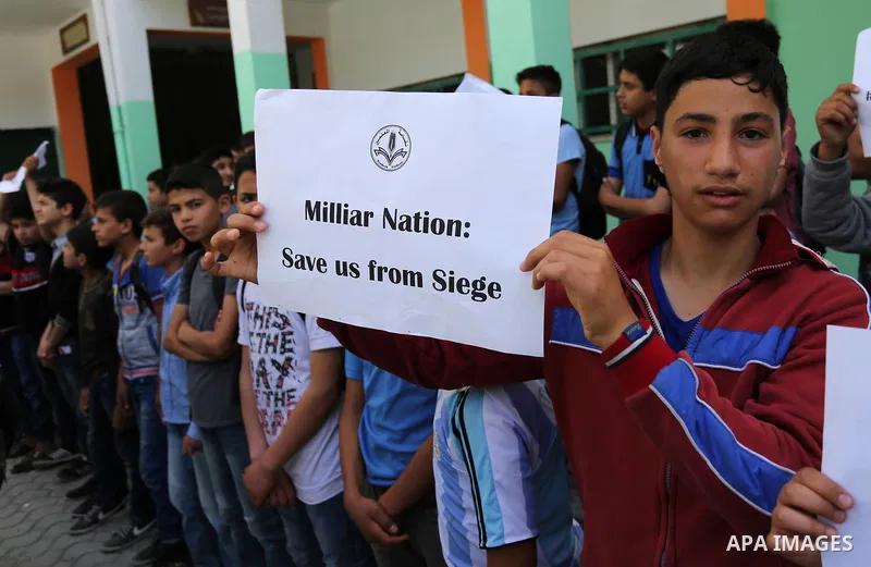 Palestinian students hold banners during a protest against Israeli blockade of the Gaza Strip, in Gaza city, on May 10, 2017. Photo by Ashraf Amra