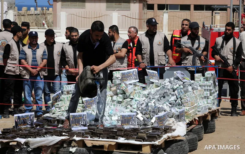 Members of Palestinian anti-drug police burn drugs that were seized by forces, in Gaza City May 11, 2017. Photo by Ashraf Amra