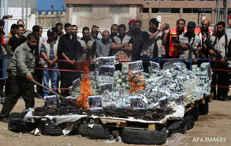 Members of Palestinian anti-drug police burn drugs that were seized by forces, in Gaza City May 11, 2017. Photo by Ashraf Amra