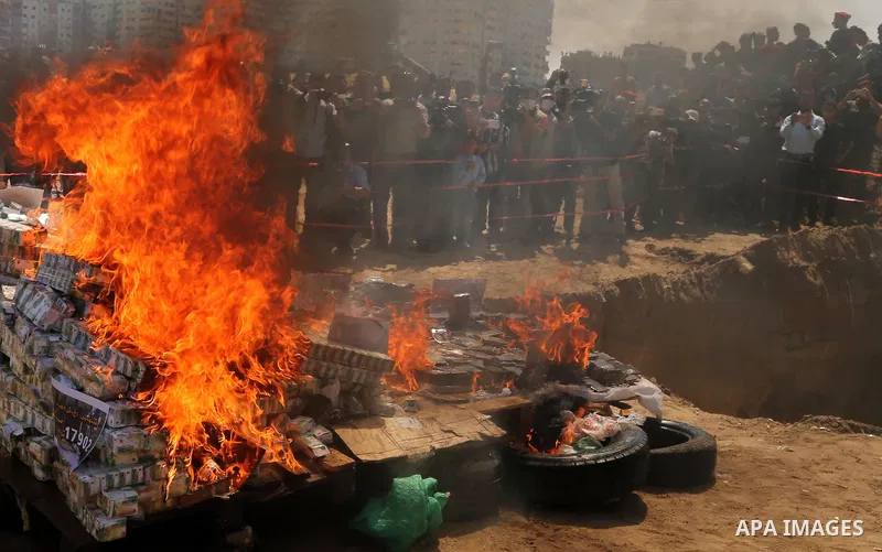 Members of Palestinian anti-drug police burn drugs that were seized by forces, in Gaza City May 11, 2017. Photo by Ashraf Amra