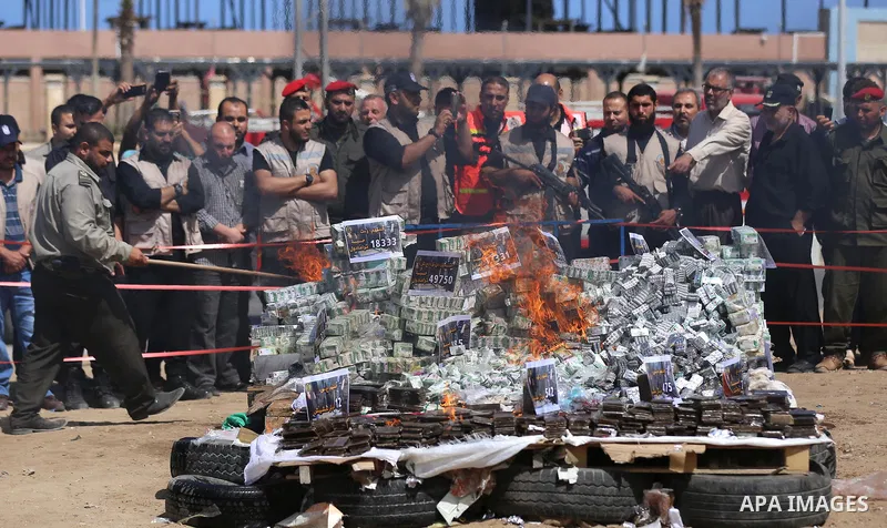 Members of Palestinian anti-drug police burn drugs that were seized by forces, in Gaza City May 11, 2017. Photo by Ashraf Amra