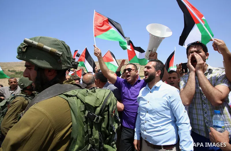 Palestinian protesters argue with Israeli soldiers during a demonstration in solidarity with Palestinian hunger-striking prisoners held in Israeli jails, at Israeli checkpoint of Hawara, near the West Bank city of Nablus...