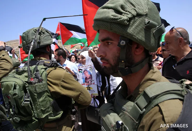 Palestinian protesters argue with Israeli soldiers during a demonstration in solidarity with Palestinian hunger-striking prisoners held in Israeli jails, at Israeli checkpoint of Hawara, near the West Bank city of Nablus...