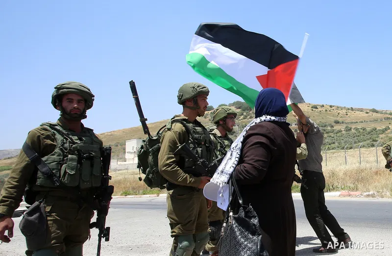 Palestinian protesters argue with Israeli soldiers during a demonstration in solidarity with Palestinian hunger-striking prisoners held in Israeli jails, at Israeli checkpoint of Hawara, near the West Bank city of Nablus...