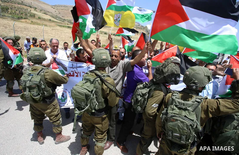 Palestinian protesters argue with Israeli soldiers during a demonstration in solidarity with Palestinian hunger-striking prisoners held in Israeli jails, at Israeli checkpoint of Hawara, near the West Bank city of Nablus...