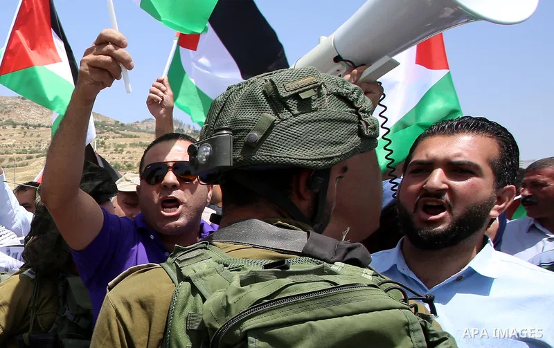 Palestinian protesters argue with Israeli soldiers during a demonstration in solidarity with Palestinian hunger-striking prisoners held in Israeli jails, at Israeli checkpoint of Hawara, near the West Bank city of Nablus...