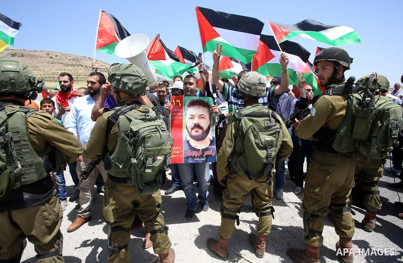 Palestinian protesters argue with Israeli soldiers during a demonstration in solidarity with Palestinian hunger-striking prisoners held in Israeli jails, at Israeli checkpoint of Hawara, near the West Bank city of Nablus...