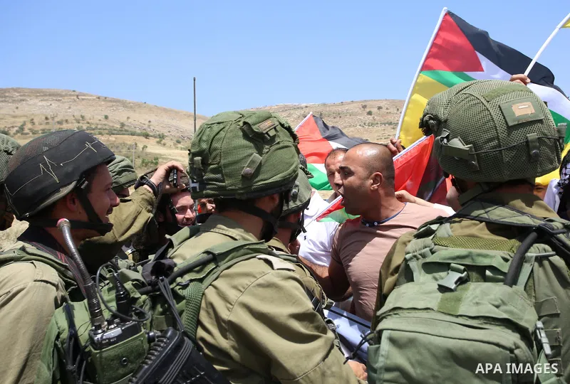 Palestinian protesters argue with Israeli soldiers during a demonstration in solidarity with Palestinian hunger-striking prisoners held in Israeli jails, at Israeli checkpoint of Hawara, near the West Bank city of Nablus...