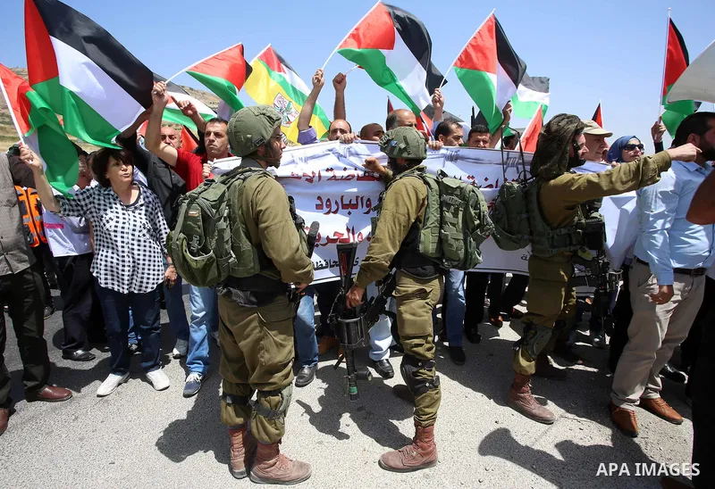 Palestinian protesters argue with Israeli soldiers during a demonstration in solidarity with Palestinian hunger-striking prisoners held in Israeli jails, at Israeli checkpoint of Hawara, near the West Bank city of Nablus...