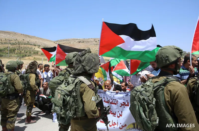 Palestinian protesters argue with Israeli soldiers during a demonstration in solidarity with Palestinian hunger-striking prisoners held in Israeli jails, at Israeli checkpoint of Hawara, near the West Bank city of Nablus...