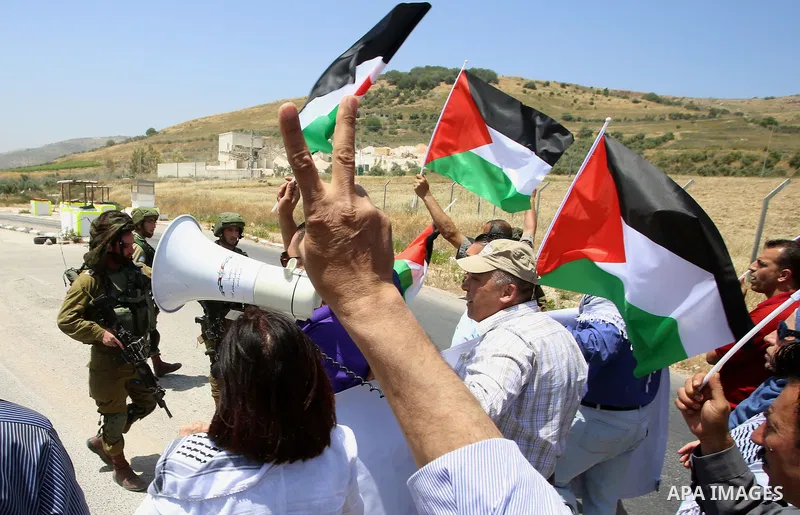 Palestinian protesters argue with Israeli soldiers during a demonstration in solidarity with Palestinian hunger-striking prisoners held in Israeli jails, at Israeli checkpoint of Hawara, near the West Bank city of Nablus...