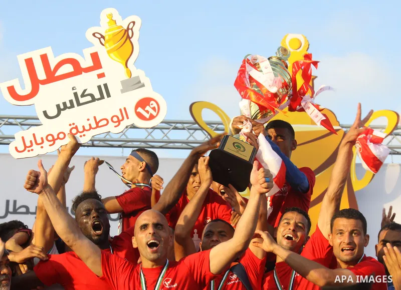 Palestinian Shabab Rafah football club players celebrate with the trophy after beating Khadamat Rafah football club during the final match of the Gaza Cup at Yarmouk stadium in Gaza City, on May 12, 2017. Photo by Ali Ha...