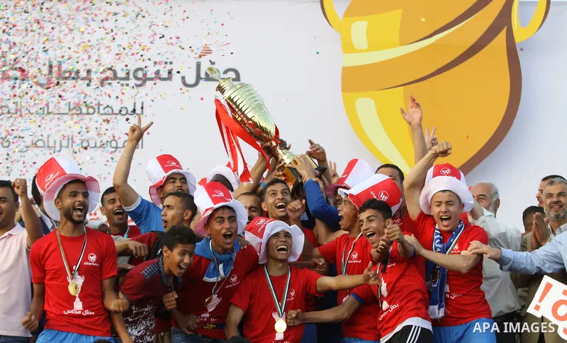Palestinian Shabab Rafah football club players celebrate with the trophy after beating Khadamat Rafah football club during the final match of the Gaza Cup at Yarmouk stadium in Gaza City, on May 12, 2017. Photo by Ali Ha...