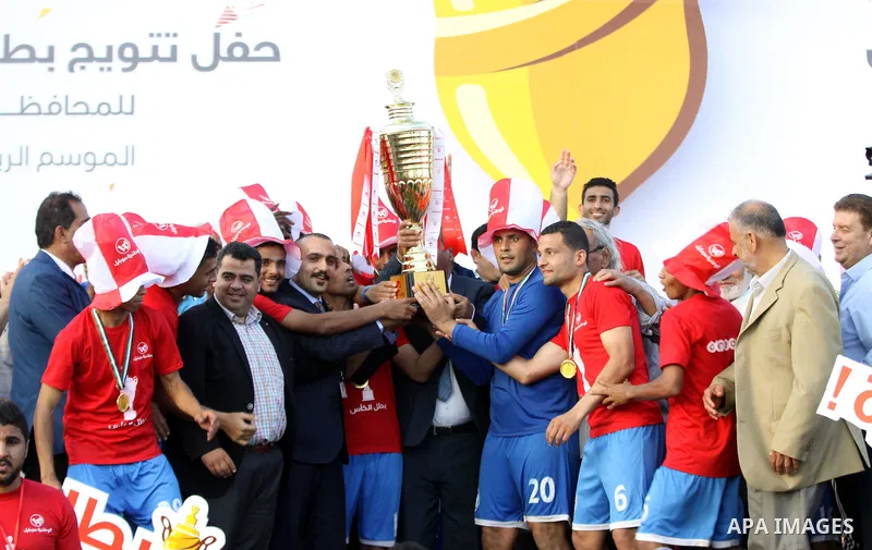 Palestinian Shabab Rafah football club players celebrate with the trophy after beating Khadamat Rafah football club during the final match of the Gaza Cup at Yarmouk stadium in Gaza City, on May 12, 2017. Photo by Ali Ha...