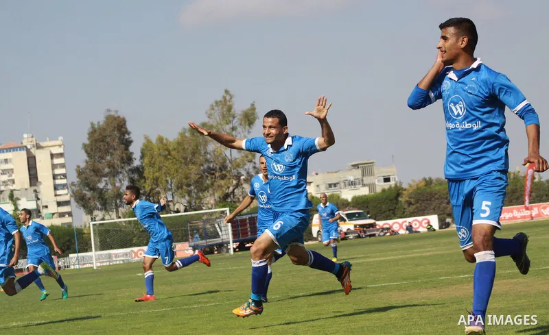 Palestinian Shabab Rafah football club players celebrate after beating Khadamat Rafah football club during the final match of the Gaza Cup at Yarmouk stadium in Gaza City, on May 12, 2017. Photo by Ali Hamad