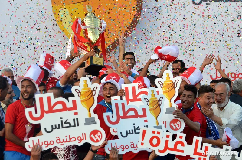 Palestinian Shabab Rafah football club players celebrate with the trophy after beating Khadamat Rafah football club during the final match of the Gaza Cup at Yarmouk stadium in Gaza City, on May 12, 2017. Photo by Mohamm...