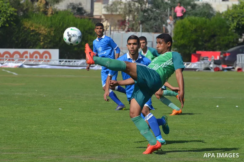 Palestinian Shabab Rafah football club players and Khadamat Rafah football club players compete during the final match of the Gaza Cup at Yarmouk stadium in Gaza City, on May 12, 2017. Photo by Mohammed El-Dalou