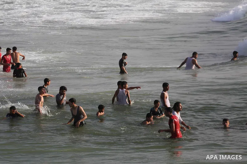 Palestinians enjoy their time off the beach of Gaza City on May 12, 2017. Photo by Mohammed Asad
