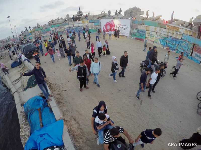 Palestinians arrive to attend the 3rd Annual Red Carpet Festival for Human Rights Films at the Gaza seaport, on May 12, 2017. The Red Carpet Festival is held in the Gaza Strip this year for the third year in a raw, amid...