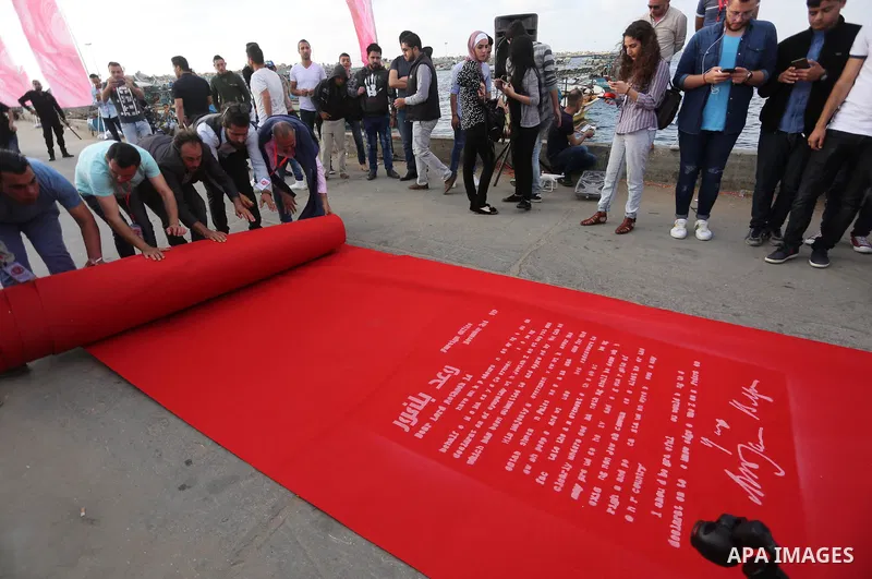 Palestinians place a red carpet during the 3rd Annual Red Carpet Festival for Human Rights Films at the Gaza seaport, on May 12, 2017. The Red Carpet Festival is held in the Gaza Strip this year for the third year in a r...