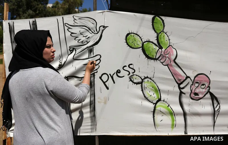 A Palestinian artist paints a mural in solidarity with Palestinian prisoners on hunger strike in Israeli jails, and to commemorate the 68th anniversary of the "Nakba" or "catastrophe" in Arabic in reference to the establ...