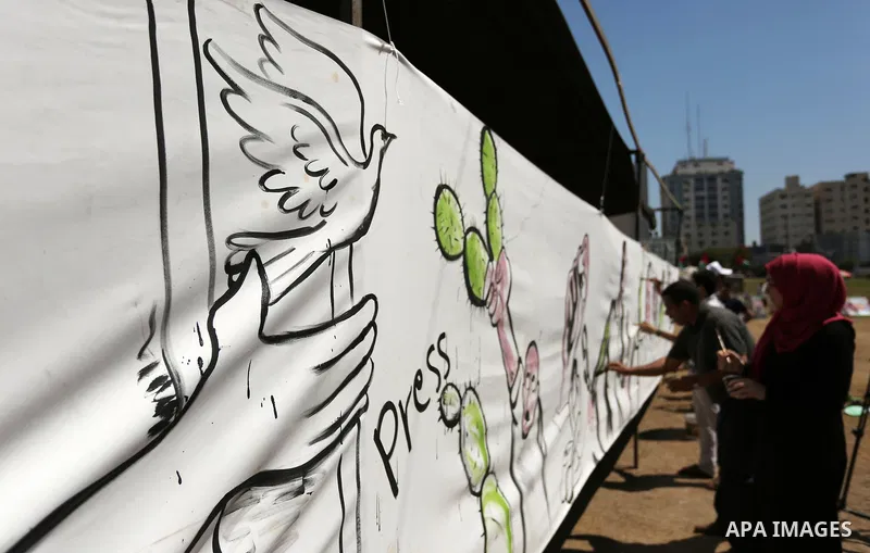 Palestinian artists paint a mural in solidarity with Palestinian prisoners on hunger strike in Israeli jails, and to commemorate the 68th anniversary of the "Nakba" or "catastrophe" in Arabic in reference to the establis...