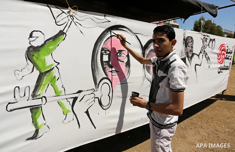 A Palestinian artist paints a mural in solidarity with Palestinian prisoners on hunger strike in Israeli jails, and to commemorate the 68th anniversary of the "Nakba" or "catastrophe" in Arabic in reference to the establ...