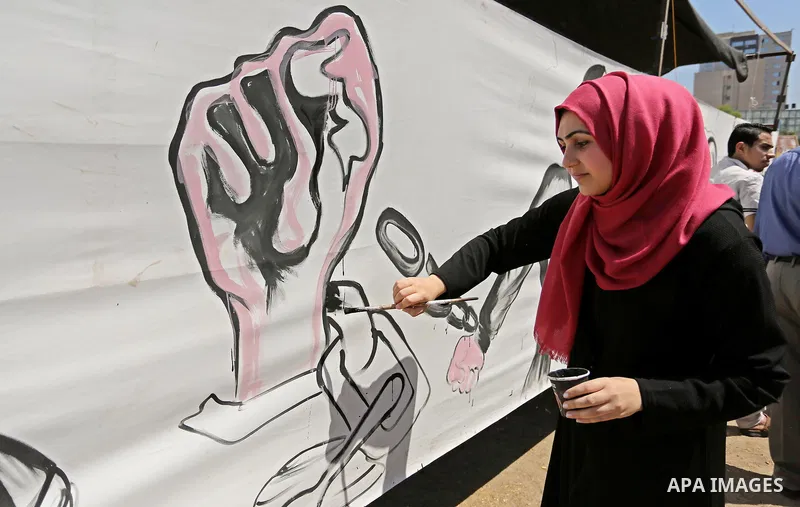 A Palestinian artist paints a mural in solidarity with Palestinian prisoners on hunger strike in Israeli jails, and to commemorate the 68th anniversary of the "Nakba" or "catastrophe" in Arabic in reference to the establ...