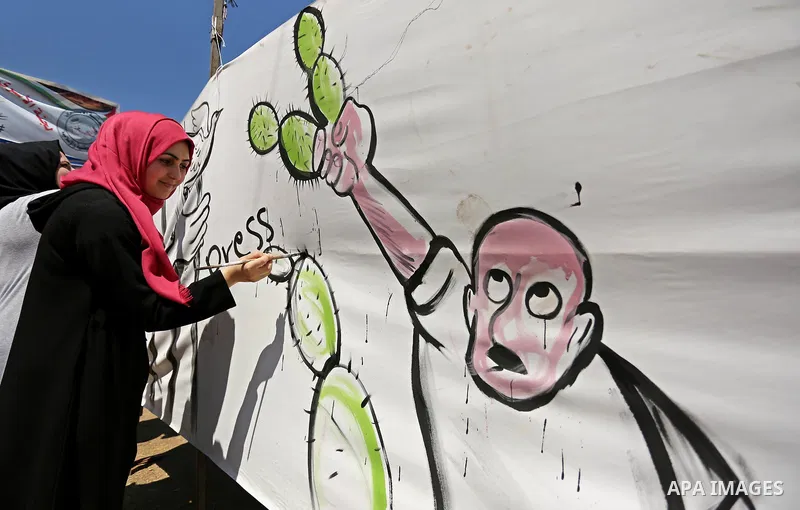 A Palestinian artist paints a mural in solidarity with Palestinian prisoners on hunger strike in Israeli jails, and to commemorate the 68th anniversary of the "Nakba" or "catastrophe" in Arabic in reference to the establ...