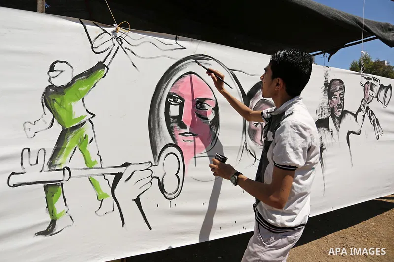 A Palestinian artist paints a mural in solidarity with Palestinian prisoners on hunger strike in Israeli jails, and to commemorate the 68th anniversary of the "Nakba" or "catastrophe" in Arabic in reference to the establ...