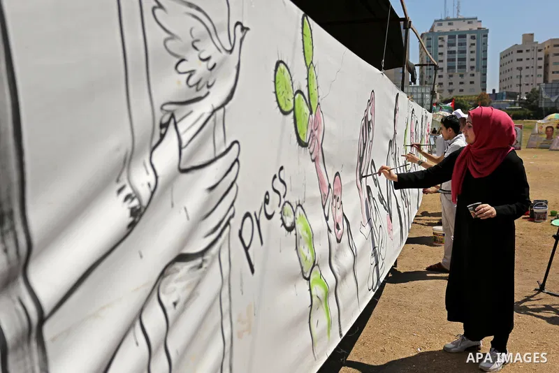 Palestinian artists paint a mural in solidarity with Palestinian prisoners on hunger strike in Israeli jails, and to commemorate the 68th anniversary of the "Nakba" or "catastrophe" in Arabic in reference to the establis...