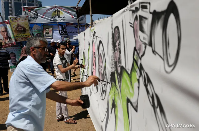 Palestinian artists paint a mural in solidarity with Palestinian prisoners on hunger strike in Israeli jails, and to commemorate the 68th anniversary of the "Nakba" or "catastrophe" in Arabic in reference to the establis...