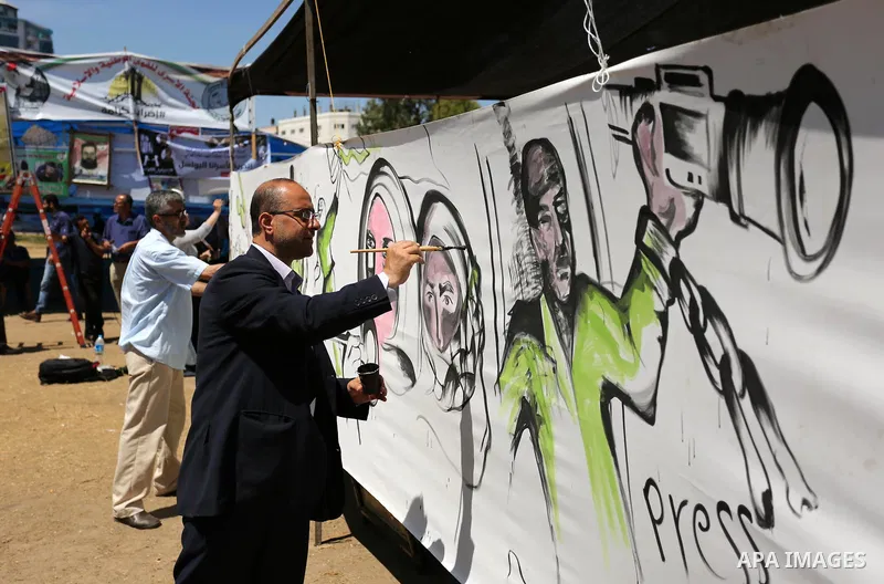 Palestinian artists paint a mural in solidarity with Palestinian prisoners on hunger strike in Israeli jails, and to commemorate the 68th anniversary of the "Nakba" or "catastrophe" in Arabic in reference to the establis...